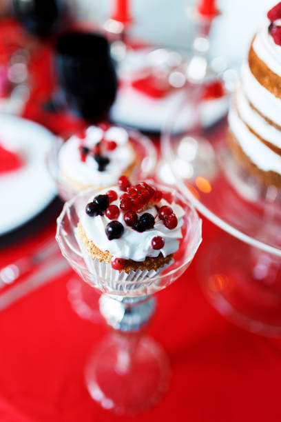 istock Delicious sweet buffet with cupcakes on red table 909679954