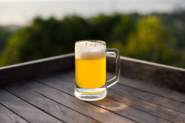 Mug with a draft beer on the nature background