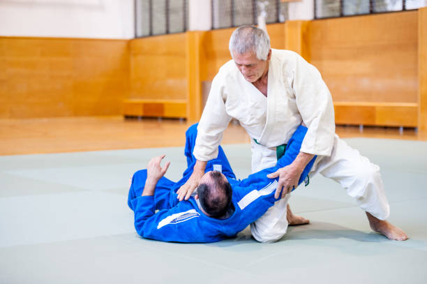 istock Senior Judo Fighter Holding Down his Rival 909682148