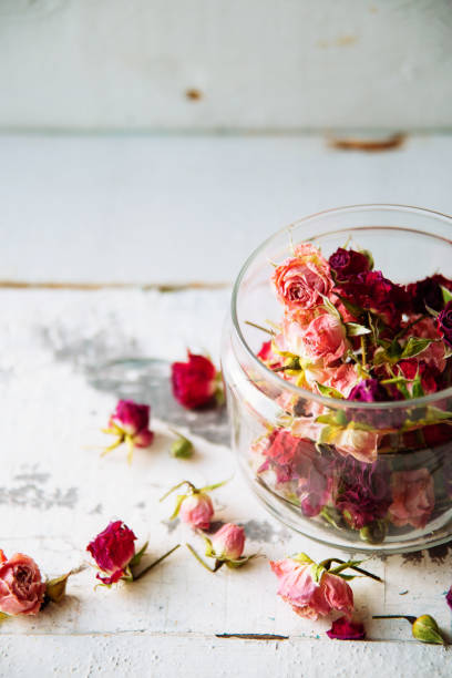 istock Rose buds tea, tea strainer and glass jar. Selective focus. 909682432