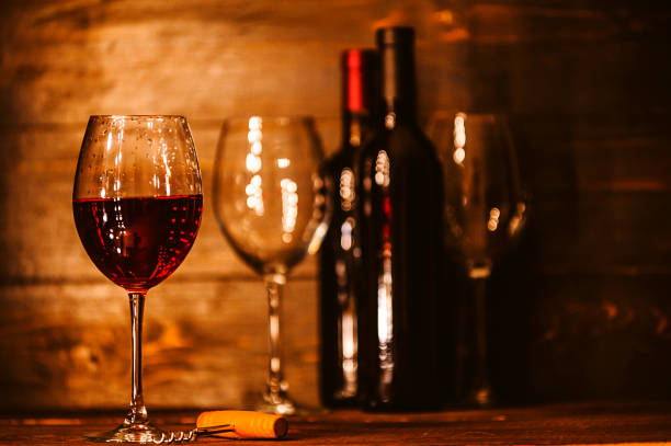 istock bottles with red wine and wine glasses on a wooden surface 909683008