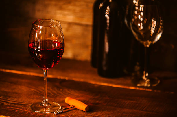 istock bottles with red wine and wine glasses on a wooden surface 909683010