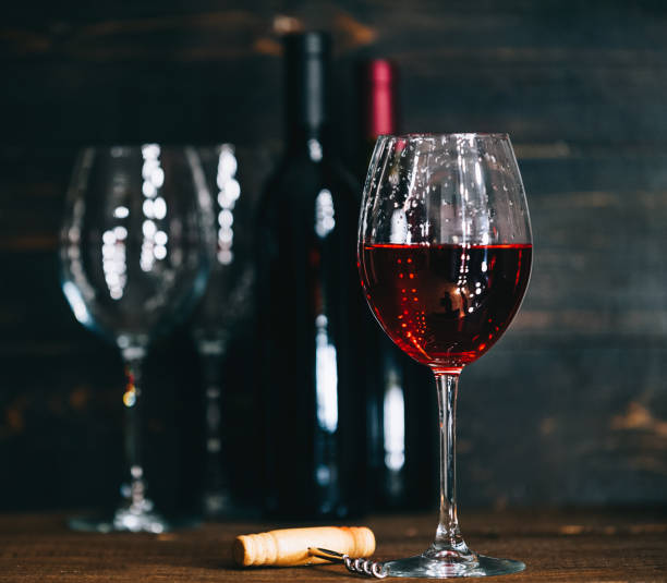 istock bottles with red wine and wine glasses on a wooden surface 909683158