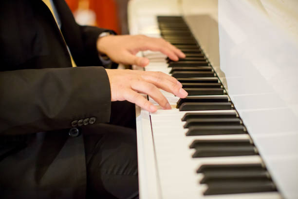 istock Hands musician playing the piano 909688416