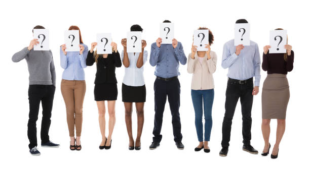 istock Group Of College Students Hiding Behind Question Mark Sign 909688822