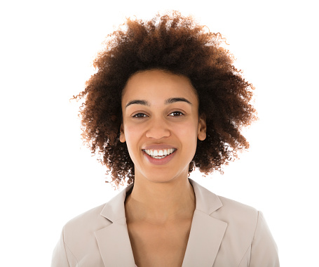 Portrait Of A Smiling Female College Student Standing Against White Background