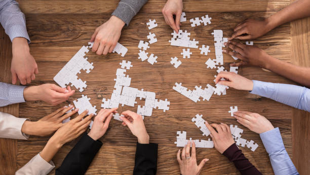 istock High Angle View Of Businesspeople Solving Jigsaw Puzzle 909688924
