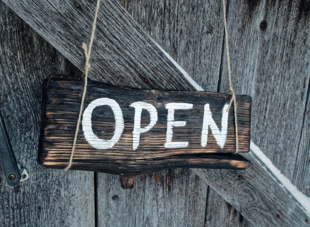 istock Open sign on old door 909689460