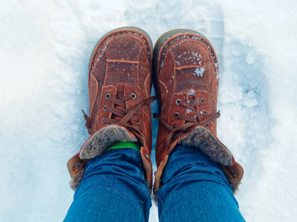 istock Feet in winter boots on the snow 909689462