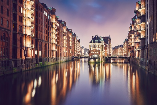 Historical buildings of the warehouse district at sunset. Speicherstadt is tourist popular place in Hamburg (Germany) on the UNESCO World Heritage Site.
