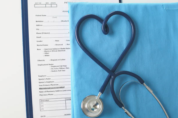 istock Stethoscope on a table with medical uniform 909692912