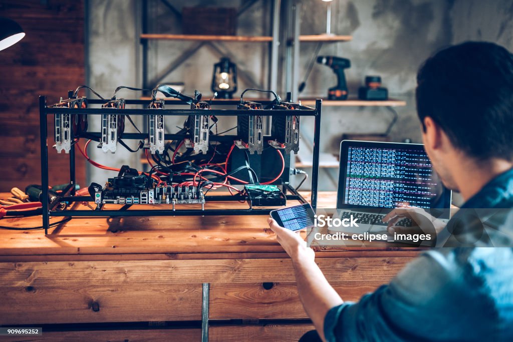 Programmer preparing mining rig with GPU Cryptocurrency Mining Stock Photo