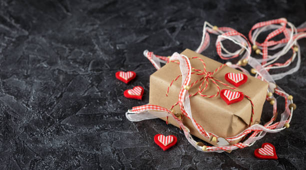 винтажная подарочная коробка (пакет) с пустым подарочным тегом на старом деревянном фоне. - felt heart shape small red стоковые фото и изображения