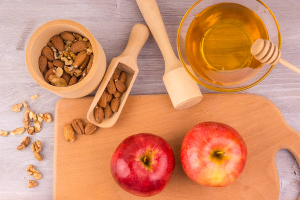 istock Red apples, nuts and honey for baking - top view 909704618
