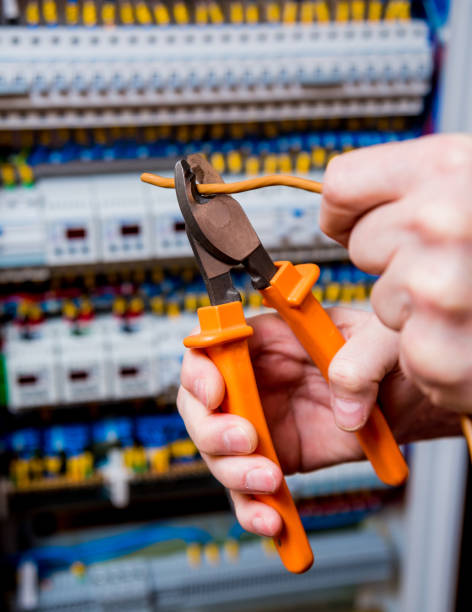 istock The man is repairing the switchboard voltage with automatic switches. 909708430