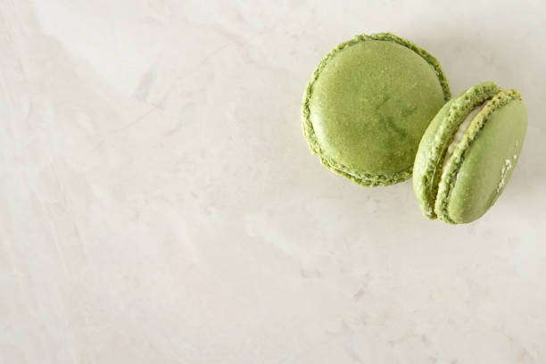 istock French dessert macaroons with pistachios and strawberries. White background 909713876