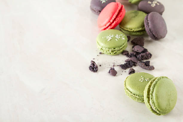 istock French dessert macaroons with pistachios and strawberries. White background 909713878