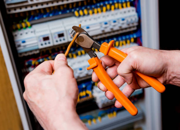 istock The man is repairing the switchboard voltage with automatic switches. 909714906