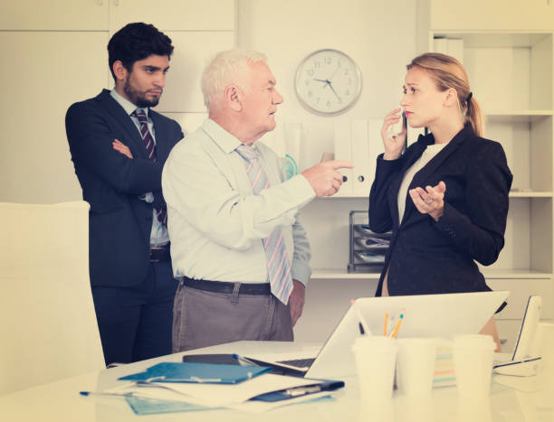 Mature boss is chastising employees because of uncompleted work Mature boss is chastising employees because of uncompleted work in the office. uncompleted stock pictures, royalty-free photos & images