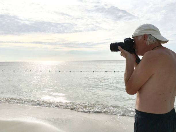 istock Senior Photographer on a Tropical Beach 909719142