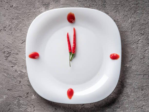 istock Hot chilli pepper on white plate with decor ketchup 909738902