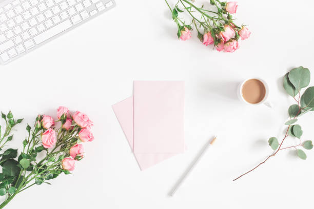 Computer, rose flowers, eucalyptus branch. Flat lay, top view