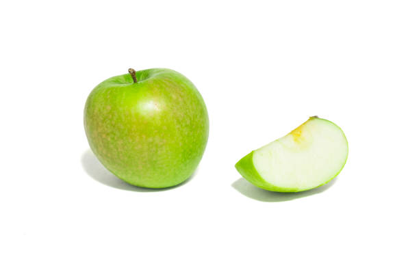 istock Green apples and apple slices isolated on white background. 909752506