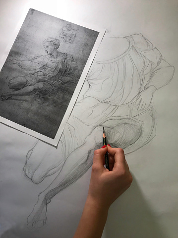 student doing charcoal drawing