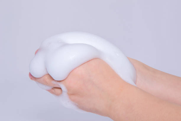 istock Foam of soap or shampoo on female hands 909755604