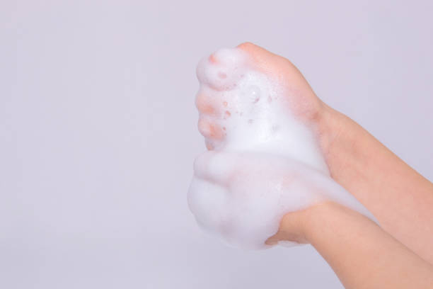 istock Foam of soap or shampoo on female hands 909755618