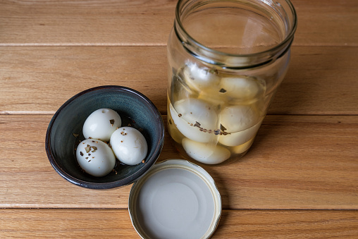 a bowl and jar of pickled eggs