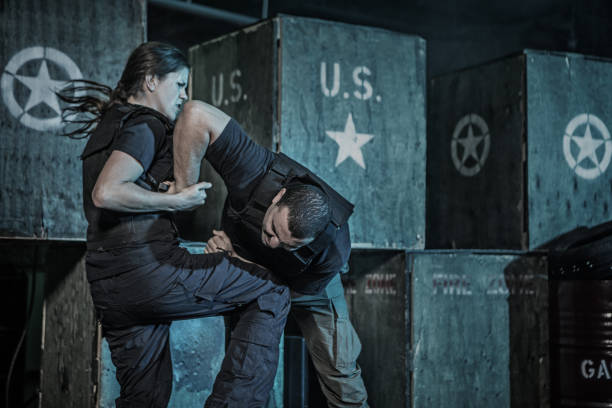 istock Single woman using Krav Maga fighting style during attack in dark indoor urban setting 909765662