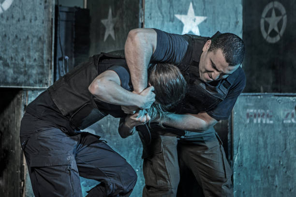 istock Single woman using Krav Maga fighting style during attack in dark indoor urban setting 909765670
