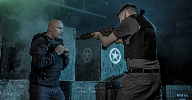 istock Two men using Krav Maga fighting style during disarmament in dark indoor urban setting 909765704