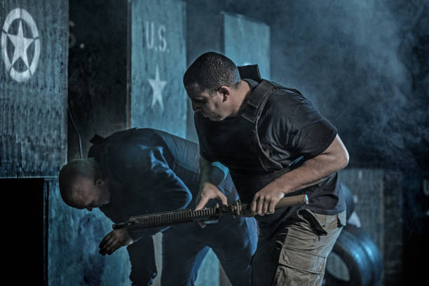 istock Two men using Krav Maga fighting style during disarmament in dark indoor urban setting 909768450