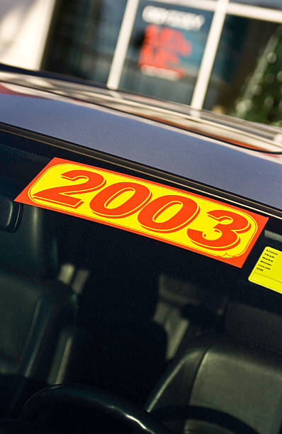 istock Used 2003 Model Automobile on Car Dealership Lot 90977211