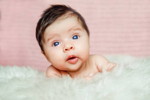 istock newborn baby lying with open eyes in crib 909772320