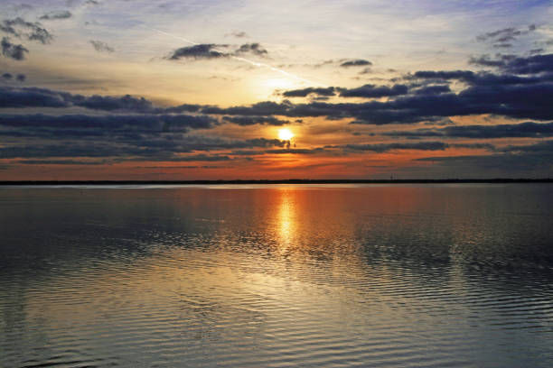 istock Sunset sunrise gold sun dark clouds 909775966