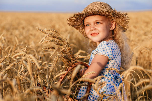 istock Happy child in autumn wheat field 909782200