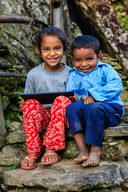 istock Nepali children using digital tablet near Annapurna Range 909784904
