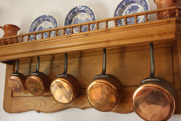istock Hanging copper pots in an old-fashioned kitchen 909788704