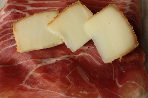 istock Raclette cheese  Slices of raw ham 909788934