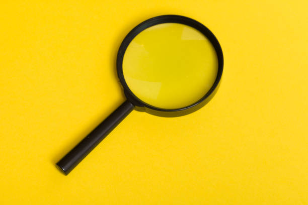 istock Magnifying Glass on yellow background 909792452