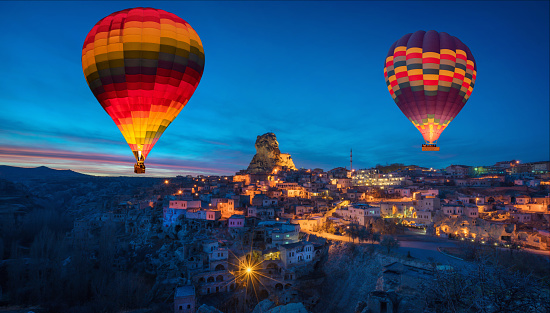 Albuquerque, New Mexico - USA - Oct 8, 2023: Several hot air balloons glowing after sunset at the Albuquerque International Balloon Fiesta