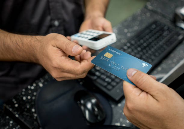 istock Customer paying by card at a store 909805766