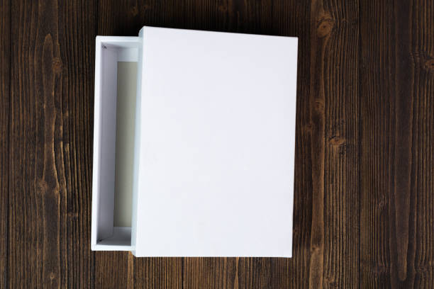 istock Empty white gift box or tray for mock up on dark wooden table with copy space. 909806060