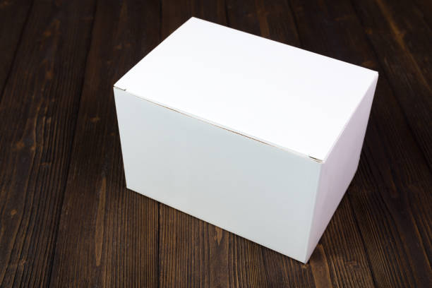 istock Empty white gift box or tray for mock up on dark wooden table with copy space. 909806066