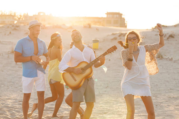 istock Young people at the beach 909810464