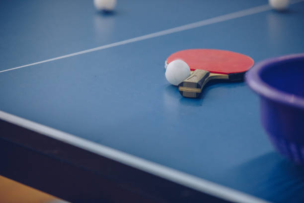 istock Ping pong racket and ball 909814050