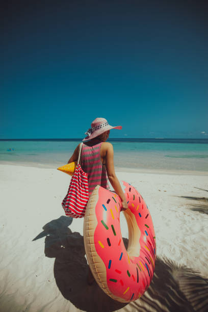 Hipster woman walking through sandy beach